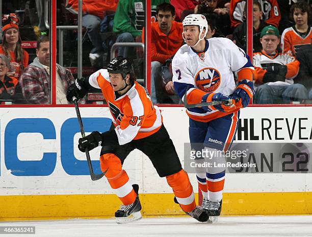 Jay Rosehill of the Philadelphia Flyers skates against Matt Carkner of the New York Islanders on January 18, 2014 at the Wells Fargo Center in...