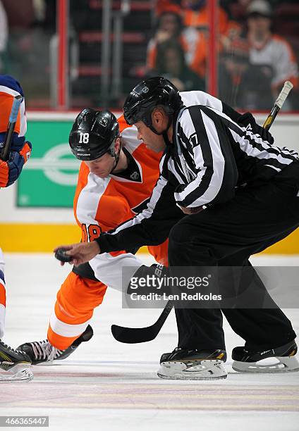 Linesmen Jay Sharrers drops the puck on a face-off between Adam Hall of the Philadelphia Flyers and a member of the New York Islanders on January 18,...
