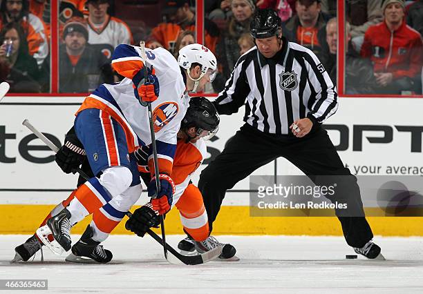 Linesmen Jay Sharrers drops the puck on a face-off between Sean Couturier of the Philadelphia Flyers and Josh Bailey of the New York Islanders on...