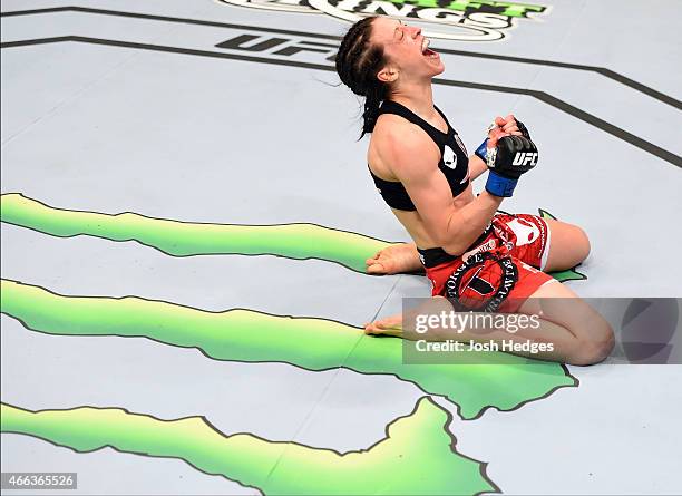 Joanna Jedrzejczyk celebrates after defeating Carla Esparza by TKO in their UFC women's strawweight championship bout during the UFC 185 event at the...