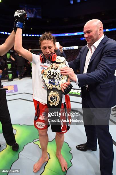 President Dana White gives Joanna Jedrzejczyk the UFC women's strawweight championship belt after defeating Carla Esparza by TKO during the UFC 185...