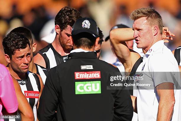 Head coach Nathan Buckley of the Magpies talks to his players during the NAB Challenge AFL match between the Collingwood Magpies and the Carlton...