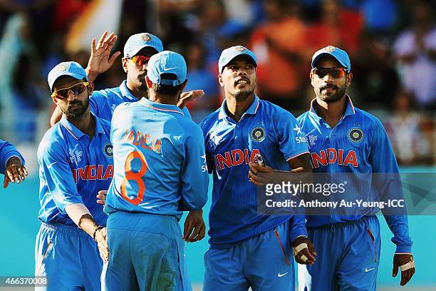 Umesh Yadav of India celebrates his wicket of Tendai Chatara of Zimbabwe during the 2015 ICC Cricket World Cup match between India and Zimbabwe at...