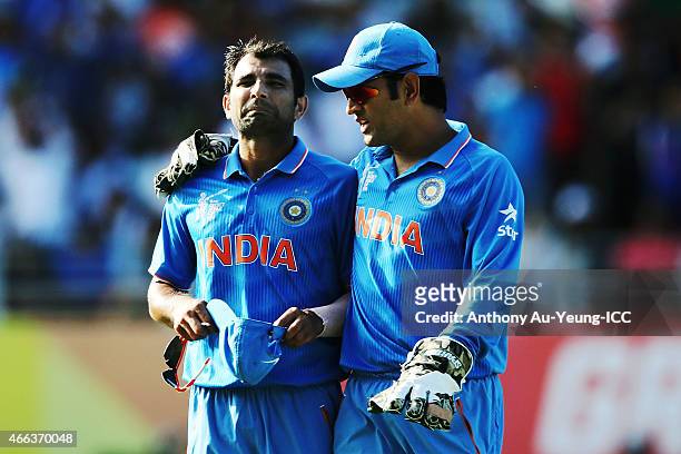 Mohammed Shami and MS Dhoni of India talk during the 2015 ICC Cricket World Cup match between India and Zimbabwe at Eden Park on March 14, 2015 in...