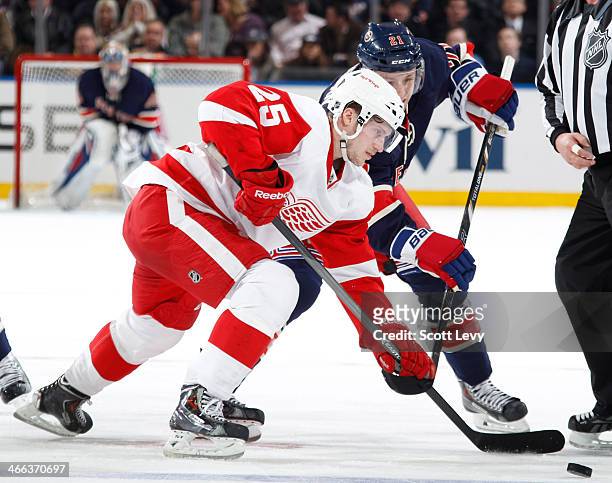 Cory Emmerton of the Detroit Red Wings wins a face-off against the New York Rangers at Madison Square Garden on January 16, 2014 in New York City....