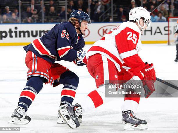 Carl Hagelin of the New York Rangers skates against Cory Emmerton of the Detroit Red Wings at Madison Square Garden on January 16, 2014 in New York...