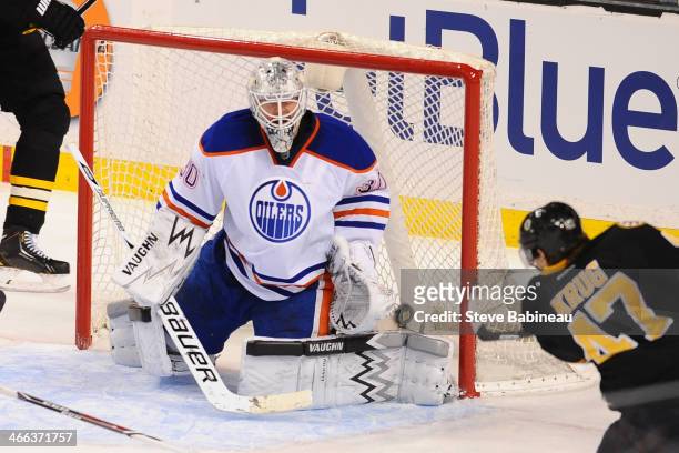 Ben Scrivens of the Edmonton Oilers misses the puck to let in a goal against Torey Krug of the Boston Bruins at the TD Garden on February 1, 2014 in...
