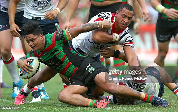 Issac Luke of the Rabbitohs scores a try in the tackle of Sio Siua Taukeiah of the Roosters during the round two NRL match between South Sydney...