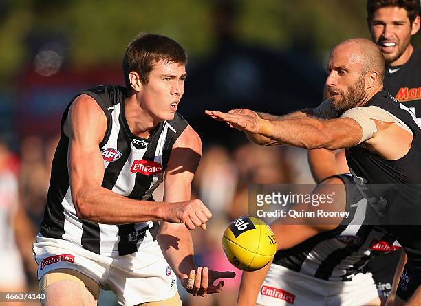 Mason Cox of the Magpies handballs during the NAB Challenge AFL match between the Collingwood Magpies and the Carlton Blues at Queen Elizabeth Oval...