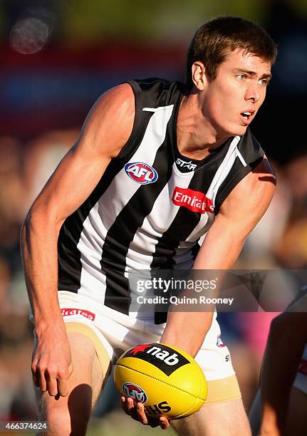 Mason Cox of the Magpies handballs during the NAB Challenge AFL match between the Collingwood Magpies and the Carlton Blues at Queen Elizabeth Oval...