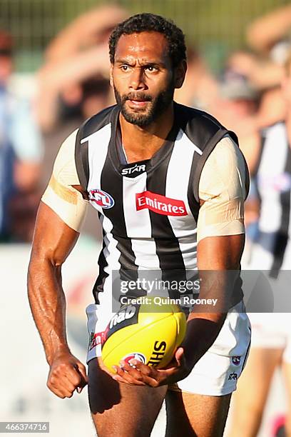 Travis Varcoe of the Magpies handballs during the NAB Challenge AFL match between the Collingwood Magpies and the Carlton Blues at Queen Elizabeth...