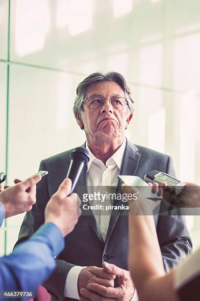 journalists questioning a mature politician - interview rejection stock pictures, royalty-free photos & images