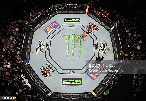 An overhead view of the Octagon as Rafael dos Anjos punches Anthony Pettis in their lightweight championship bout during the UFC 185 event at the...