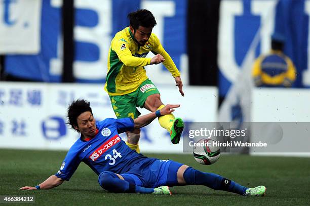 Yuto Sato of JEF United Chiba shoots while Makito Yoshida of Mito Hollyhock tries to stop during the J.League second division match between JEF...