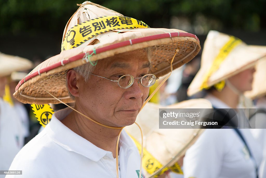 An elderly man marches to oppose nuclear energy while...