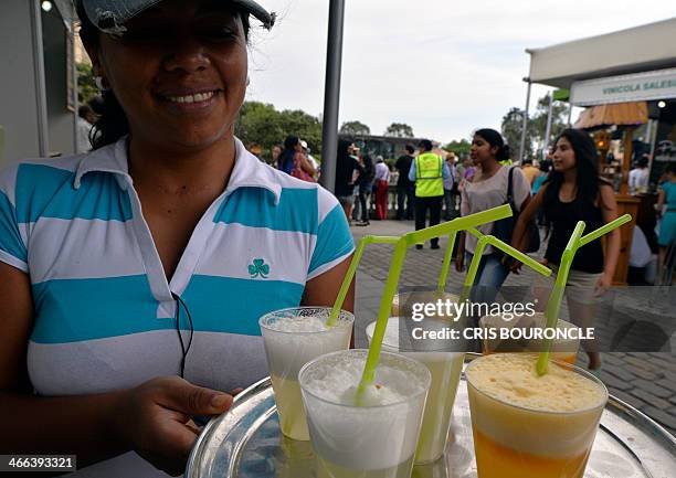 Waitress serves Pisco Sour in a street festival in Lima on February 1 during celebrations for the national Day of Pisco Sour, an alcohol cocktail...