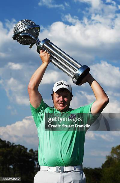 George Coetzee of South Africa holds the trophy for winning the Tshwane Open at Pretoria Country Club on March 15, 2015 in Pretoria, South Africa.
