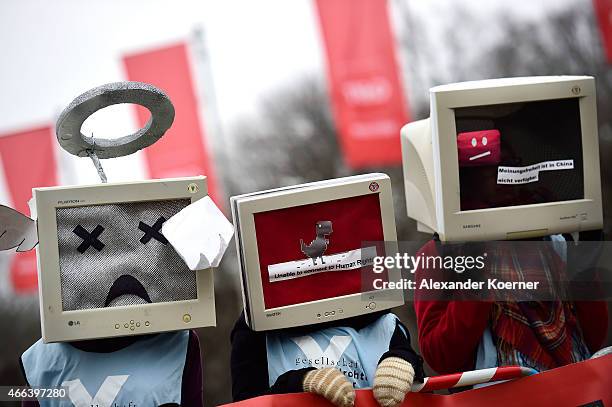 Protesters against internet censorship, wearing Computers as helmets, are seen outside Hanover Congress Centrum on March 15, 2015 in Hanover,...