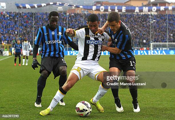 Allan Marques Loureiro of Udinese Calcio competes for the ball with Carlos Carmona and Boukary Drame of Atalanta BC during the Serie A match between...