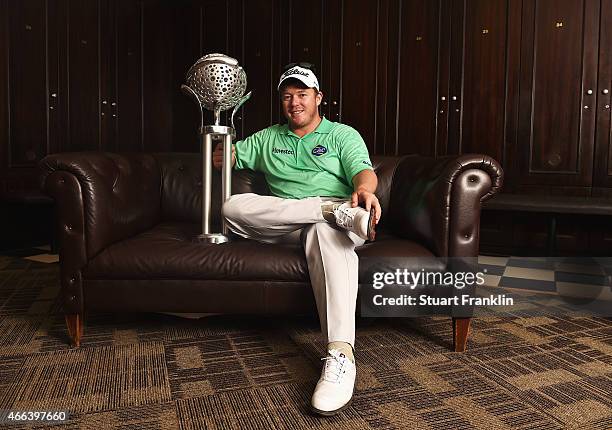 George Coetzee of South Africa poses for a picture with the trophy in the locker room after winning the Tshwane Open at Pretoria Country Club on...