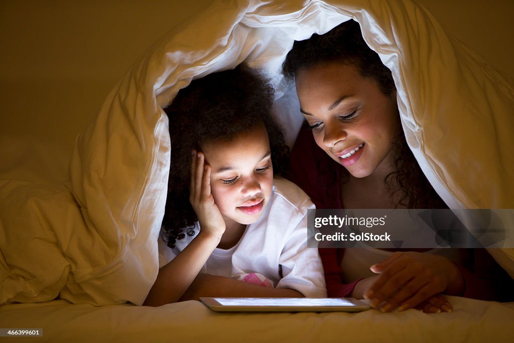 Mother and Daughter lying in bed