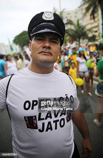 An anti-government protester poses while marching along Copacabana beach on March 15, 2015 in Rio de Janeiro, Brazil. Protests across the country...