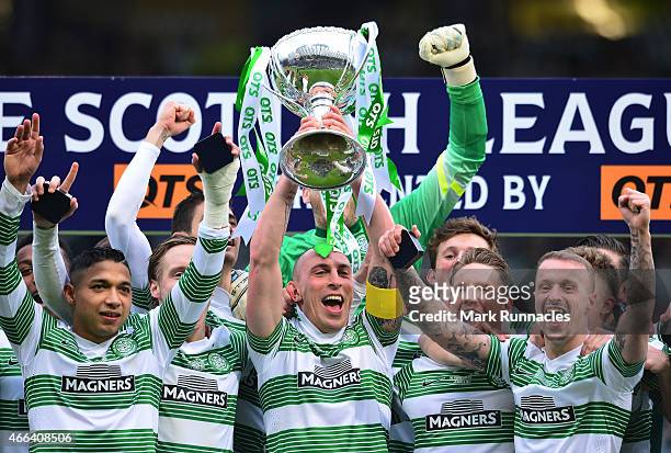 Celtic captain Scott Brown lifts the League Cup trophy as the Celtic team celebrate during the Scottish League Cup Final between Dundee United and...