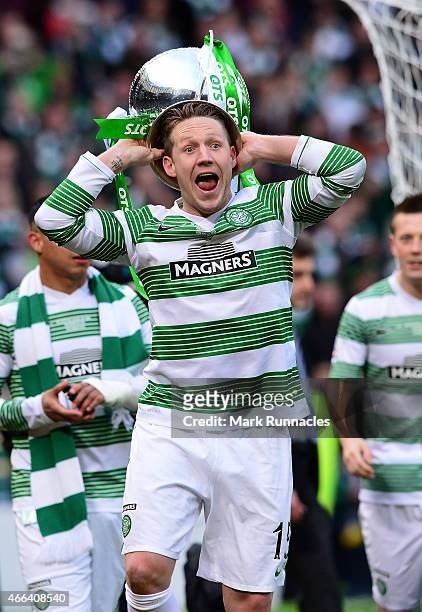 Kris Commons of Celtic lifts the League Cup trophy as the Celtic team celebrate during the Scottish League Cup Final between Dundee United and Celtic...