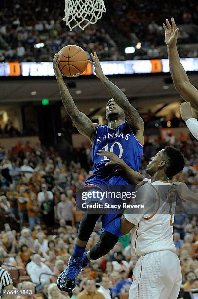 Naadir Tharpe of the Kansas Jayhawks shoots over Isaiah Taylor of the Texas Longhorns during a game at The Frank Erwin Center on February 1, 2014 in...