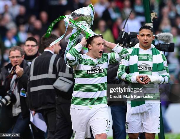 Kris Commons of Celtic lifts the League Cup trophy as the Celtic team celebrate during the Scottish League Cup Final between Dundee United and Celtic...