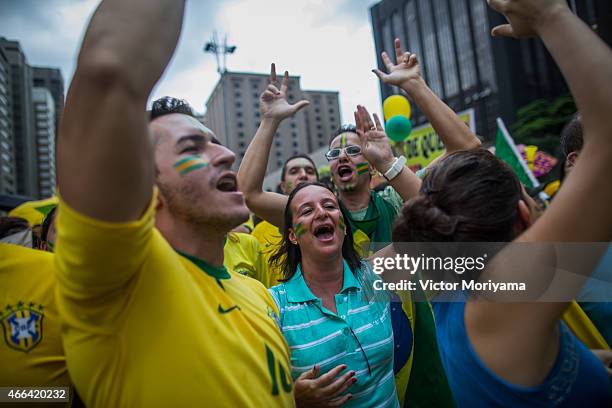 Anti-government protesters chant as they march along Avenida Paulista on March 15, 2015 in Sao Paulo, Brazil. Protests across the country were held...