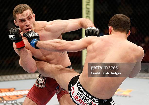 Tony Martin and Rashid Magomedov trade strikes in their lightweight fight at the the UFC 169 event inside the Prudential Center on February 1, 2014...