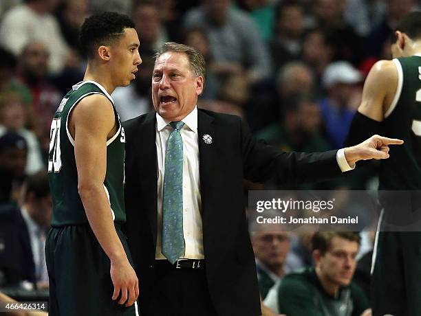 Head coach Tom Izzo of the Michigan State Spartans gives instructions to Travis Trice as they take on the Wisconsin Badgers during the Championship...
