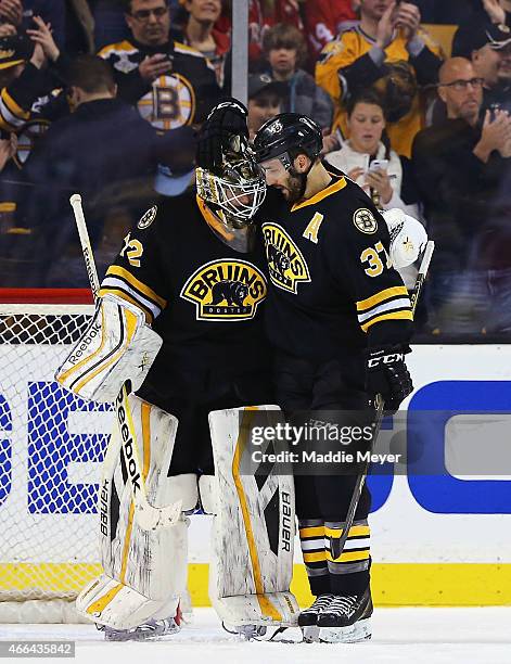 Patrice Bergeron and Niklas Svedberg of the Boston Bruins celebrate their win over the Detroit Red Wings at TD Garden on March 8, 2015 in Boston,...