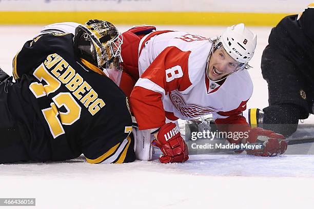 Justin Abdelkader of the Detroit Red Wings falls over Niklas Svedberg of the Boston Bruins in an attempt to score in the second period at TD Garden...