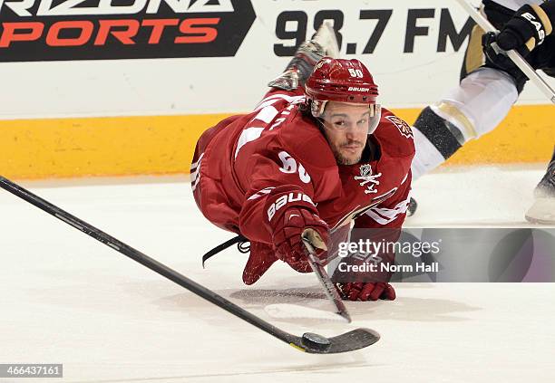 Antoine Vermette of the Phoenix Coyotes dives for the puck against the Pittsburgh Penguins at Jobing.com Arena on February 1, 2014 in Glendale,...