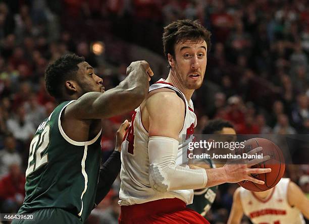 Frank Kaminsky of the Wisconsin Badgers moves against Branden Dawson of the Michigan State Spartans during the Championship game of the 2015 Big Ten...