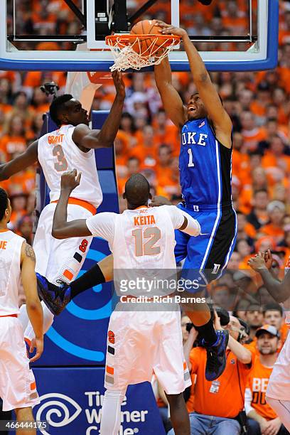 Jabari Parker of the Duke Blue Devils dunks the ball against Jerami Grant and Baye Moussa Keita of the Syracuse Orange during the first half at the...