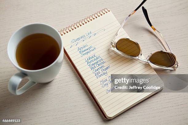 shopping list with tea cup - shopping list stock pictures, royalty-free photos & images
