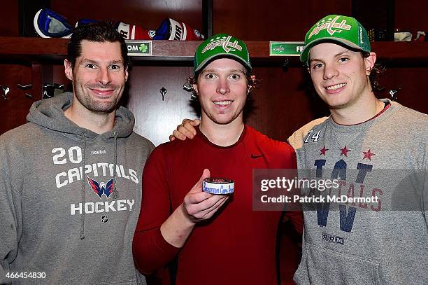 Nicklas Backstrom of the Washington Capitals poses for a photo with teammates Troy Brouwer and John Carlson after becoming the franchise assists...