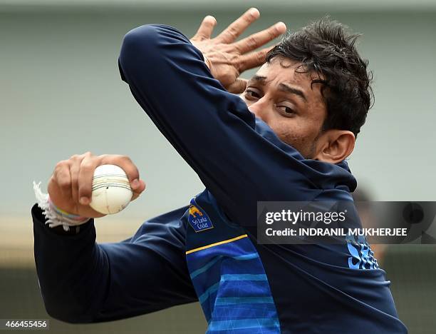 Sri Lankan cricketer Tillakaratne Dilshan bowls during a training session at the Sydney Cricket Ground ahead of the 2015 Cricket World Cup first...