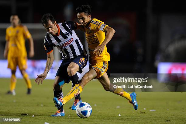 Lucas Lobos of Tigres fights for the ball with Cesar Delgado of Monterrey during a match between Monterrey and Tigres UANL as part of the Clausura...