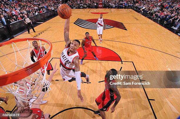 Damian Lillard of the Portland Trail Blazers dunks against the Toronto Raptors on February 1, 2014 at the Moda Center Arena in Portland, Oregon. NOTE...