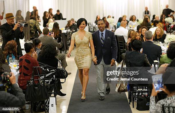 Angela Rossum and Allen Rossum walk the runway at the Saks Fifth Avenue And Off The Field Players' Wives Association Charitable Fashion Show on...