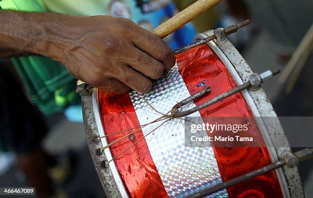 Drummer prepares to play in the first street parade of the 2014 Carnival season through the historic Afro-Brazilian port district during the Circuito...