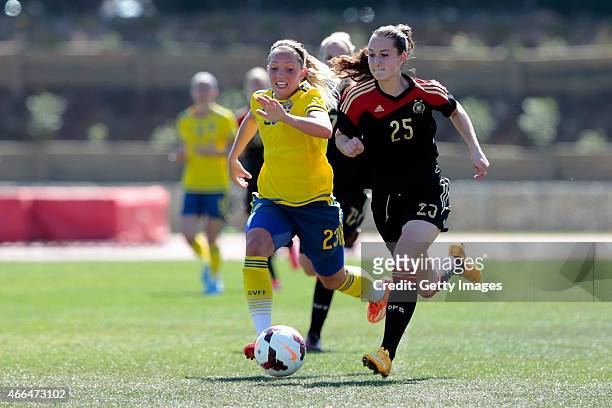 Sara Dabritz of Germany challenged by Elin Rubensson of Sweden during the Women's Algarve Cup 3rd place match between Sweden and Germany at Municipal...