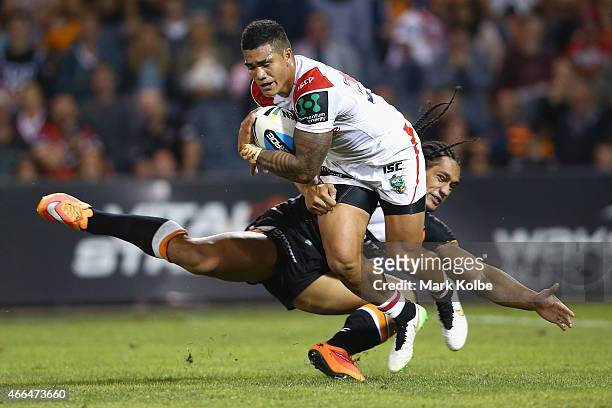 Peter Mata'Utia of the Dragons is tackled by Martin Taupau of the Tigers during the round two NRL match between the Wests Tigers and the St George...
