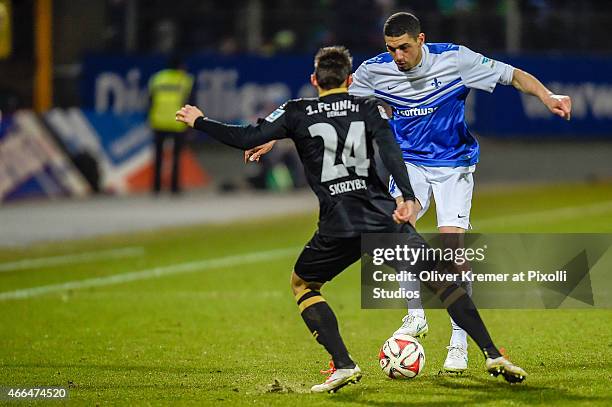 Leon Balogun runs at Steven Skrzybski during the Second Bundesliga match between SV Darmstadt 98 and 1. FC Union Berlin at 'Merck-Stadion am...