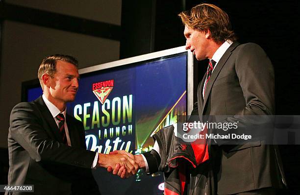 Brendon Goddard of the Bombers is presented his jumper by coach James Hird reacts during the Essendon Bombers 2015 AFL season launch at Luminare on...