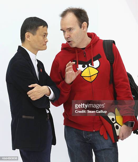 Alibaba Group Executive Chairman Jack Ma chats with Rovio Chief Marketing Officer Peter Vesterbacka of Angry Birds at the 2015 CeBIT technology trade...